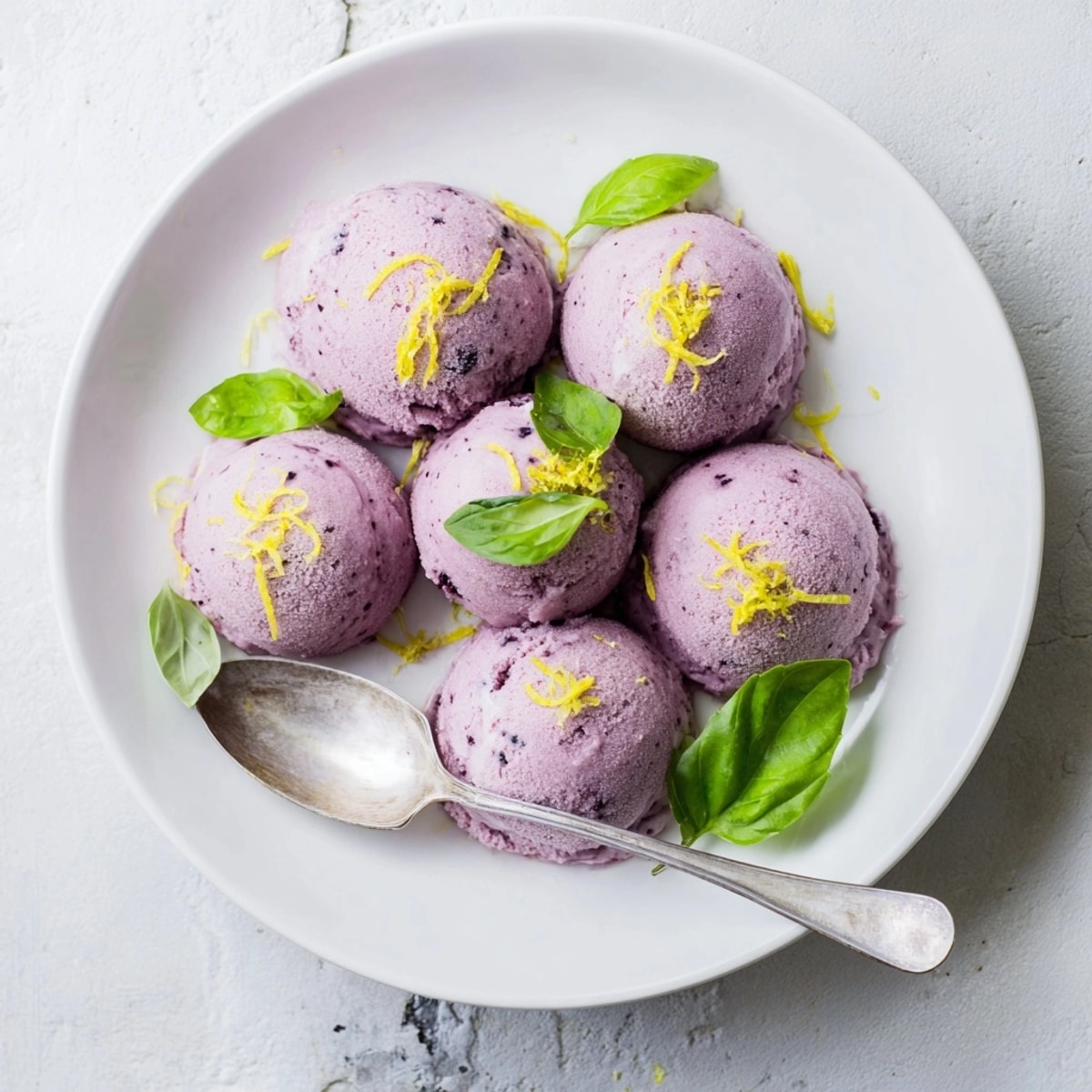 Scoops of icy Blueberry &amp; Basil Lemonade Sorbet a perfect fruity sweet vegan summer treat.