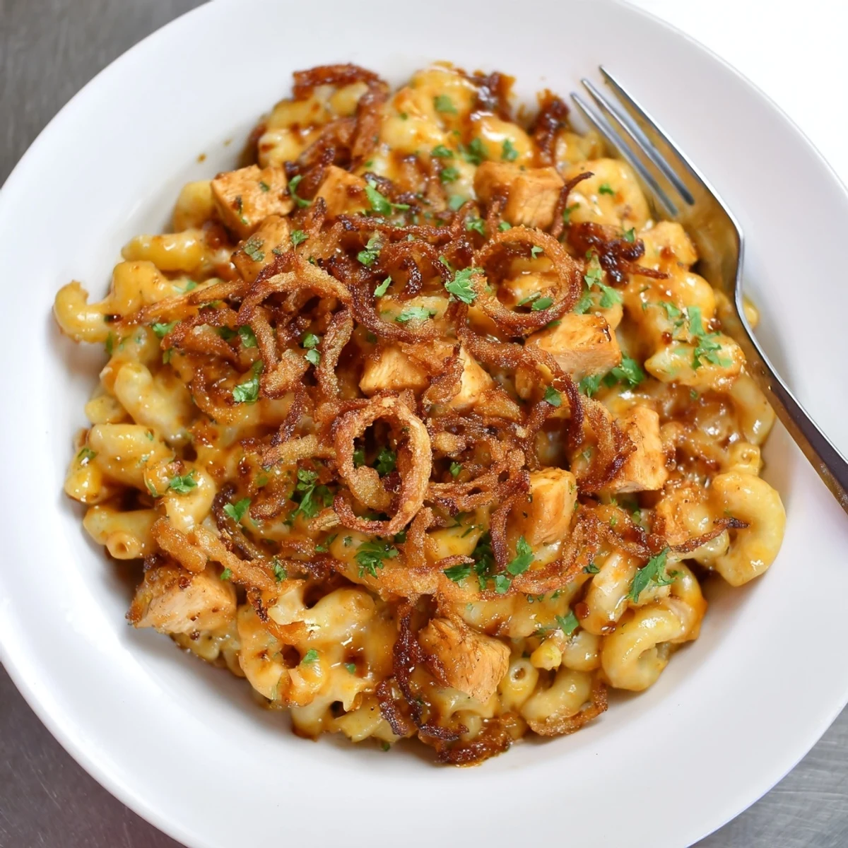 Creamy and cheesy one-pot honey BBQ chicken mac and cheese bubbling in a Dutch oven, perfect for dinner.