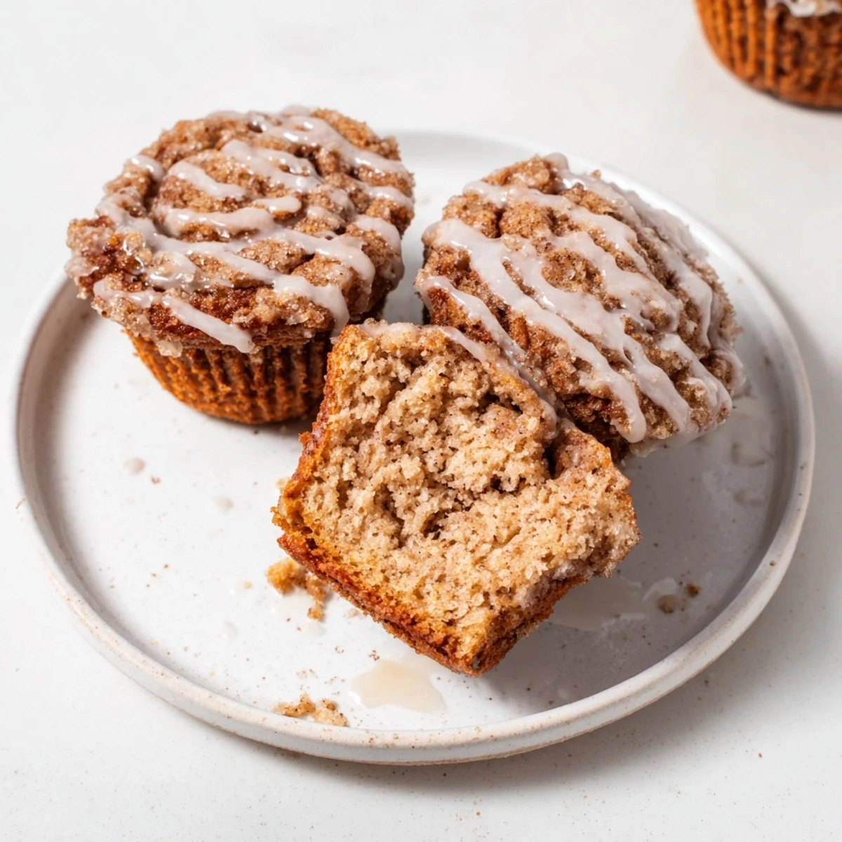 Soft, comforting cinnamon roll protein muffins, golden brown and ready to be enjoyed as a snack.