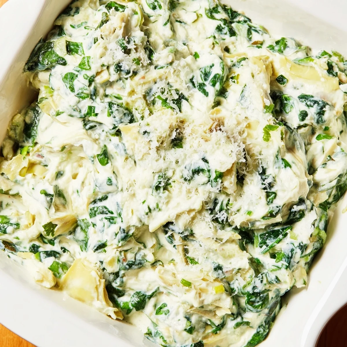 This warm, cheesy Creamy Spinach and Artichoke Dip features spinach and artichokes baked to perfection.