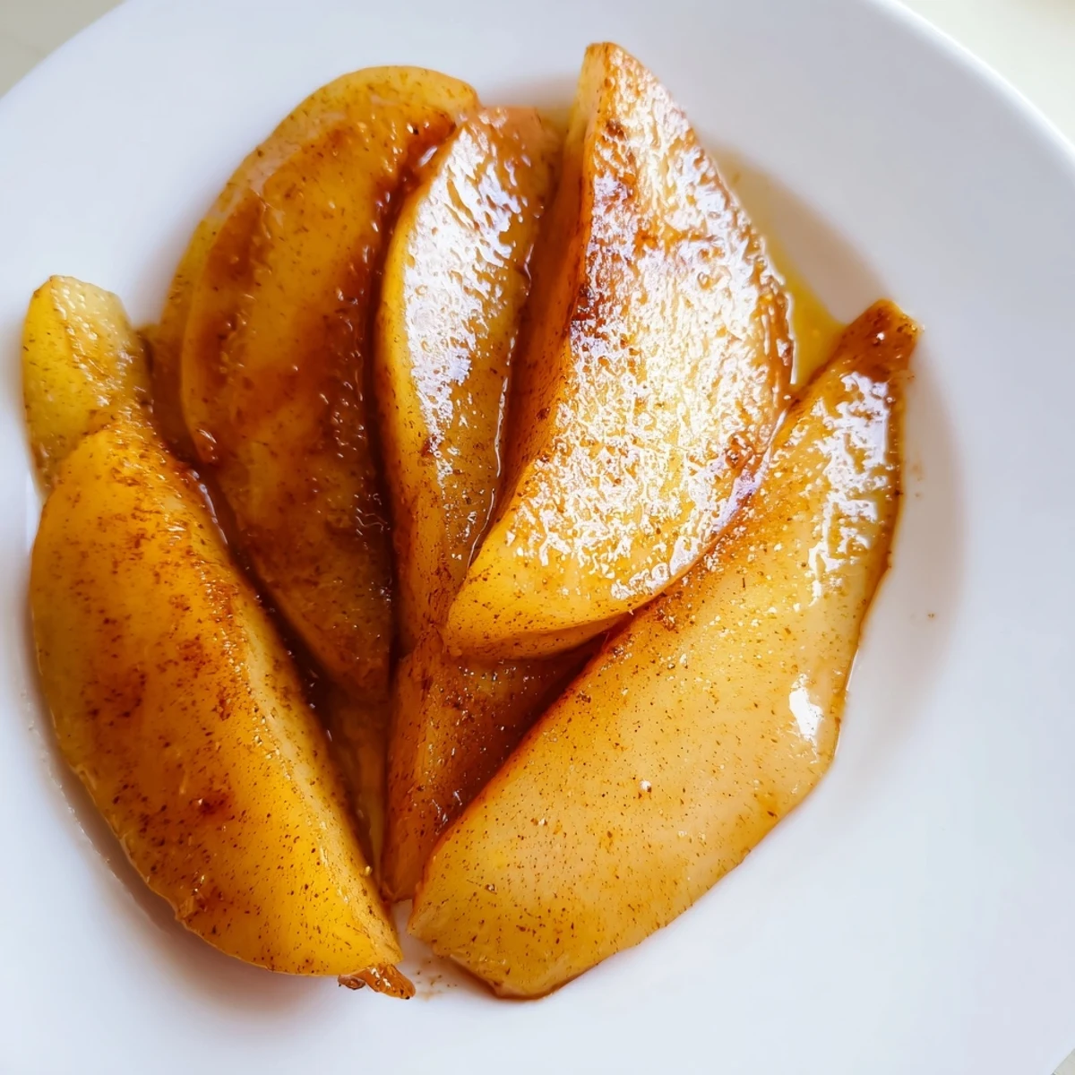 A baking dish filled with aromatic Baked Apple Slices, sprinkled nuts, ready to enjoy.
