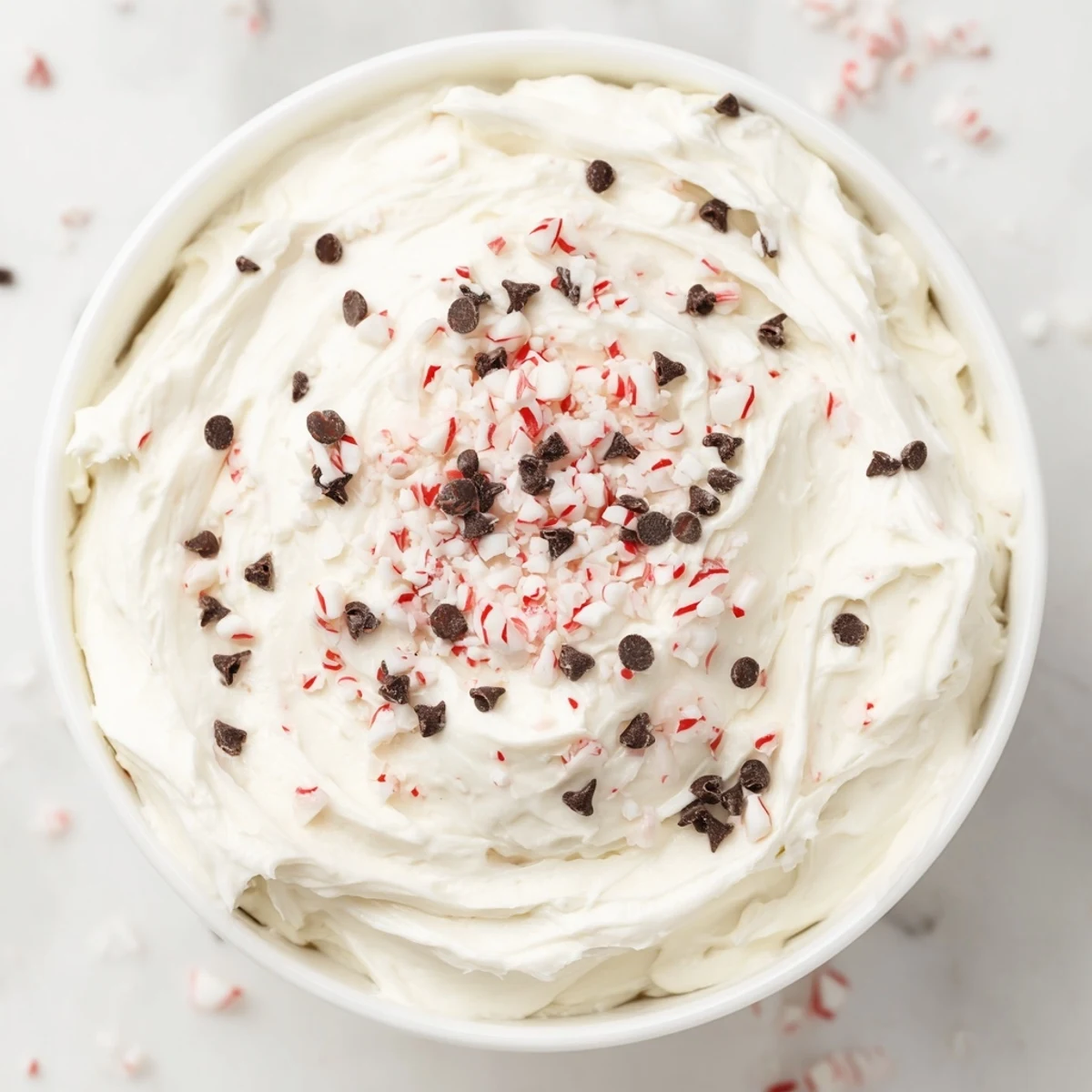 Creamy Peppermint Fluff Dip, garnished with crushed peppermint, offers a festive, chilled dessert experience.