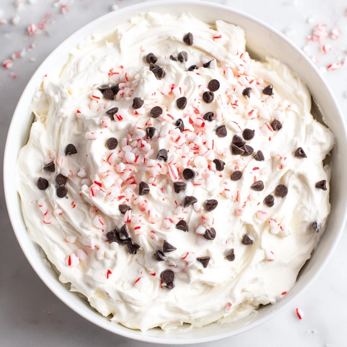 Homemade Peppermint Fluff Dip, fluffy and pink, ready to be scooped with cookies or fruit for dipping.