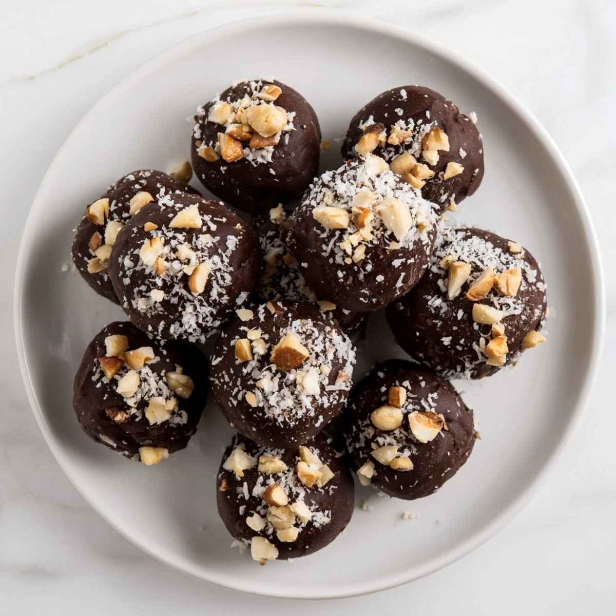 Homemade chocolate truffles, perfectly round with a nutty coating, offer a luxurious, melt-in-your-mouth experience.