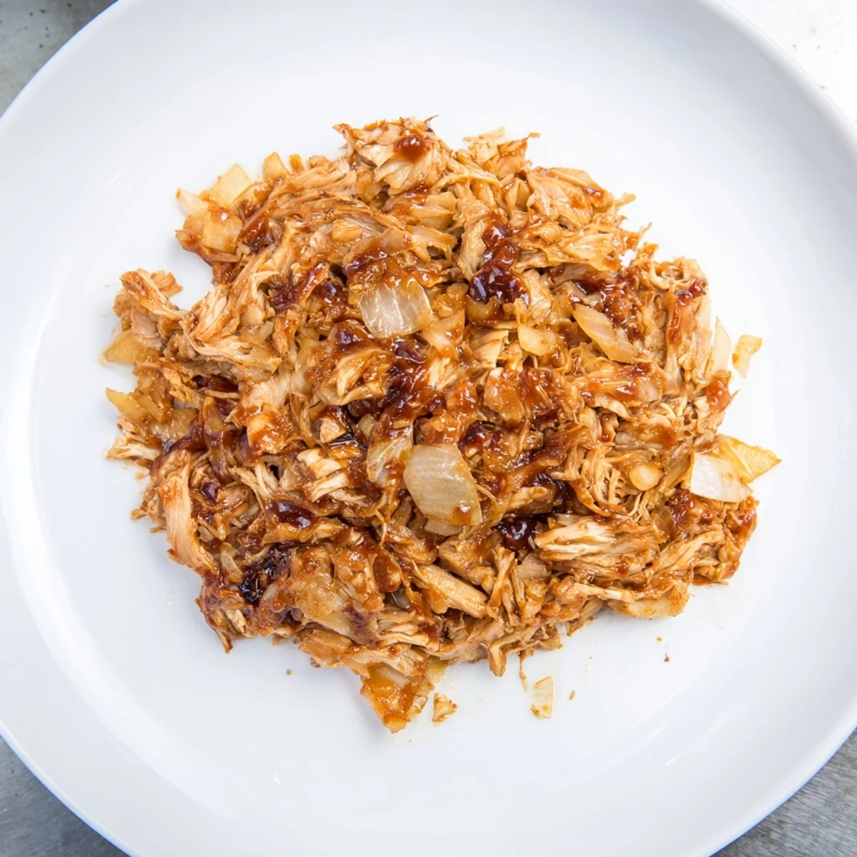 Smoky, flavorful slow-cooked pork-free pulled jackfruit, perfect filling for a delicious vegan sandwich.