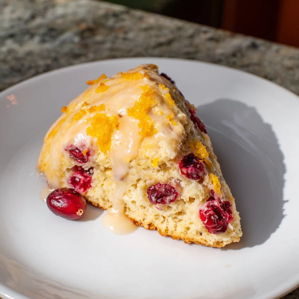Golden-brown cranberry orange scones, studded with cranberries and drizzled with a bright citrus glaze.