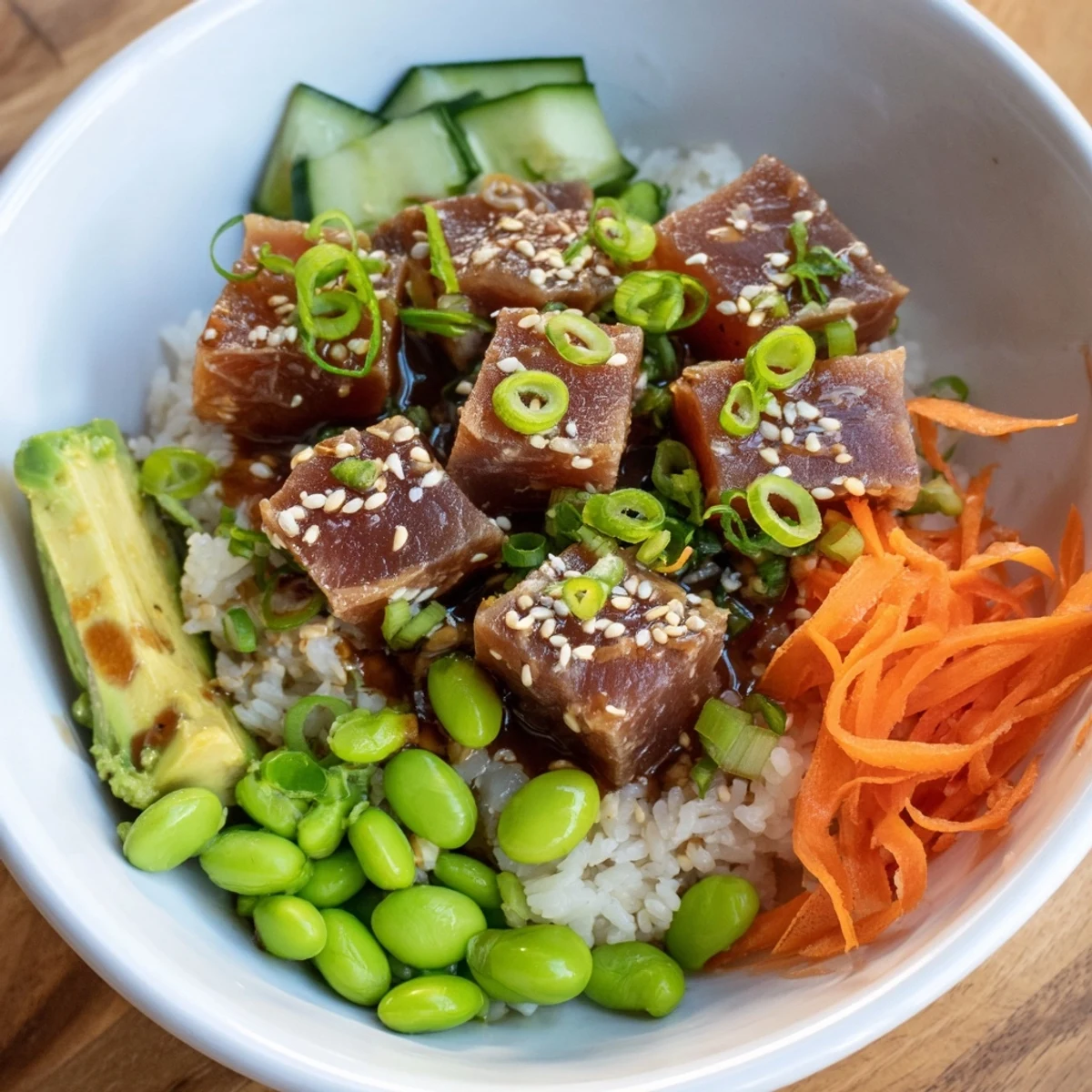 Spicy Tuna Poke Bowl with avocado, fresh and colorful, ready for a delicious pescatarian meal.