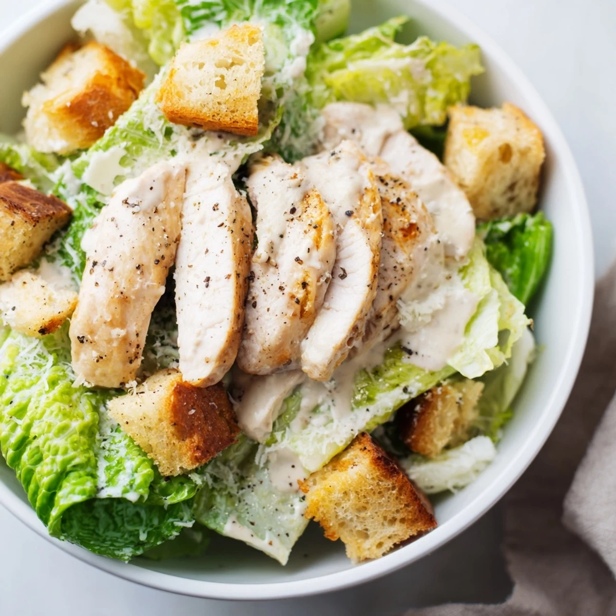 Serving suggestion for Chicken Caesar Salad with juicy grilled chicken, crunchy croutons, and fresh Parmesan.