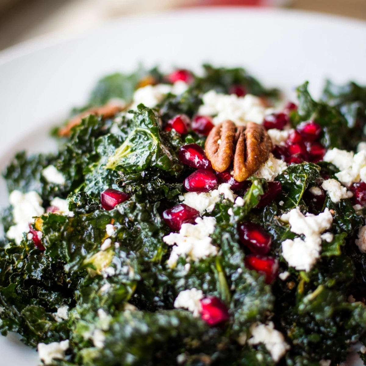 Fresh kale salad with pomegranate seeds and toasted pecans tossed in citrus dressing.
