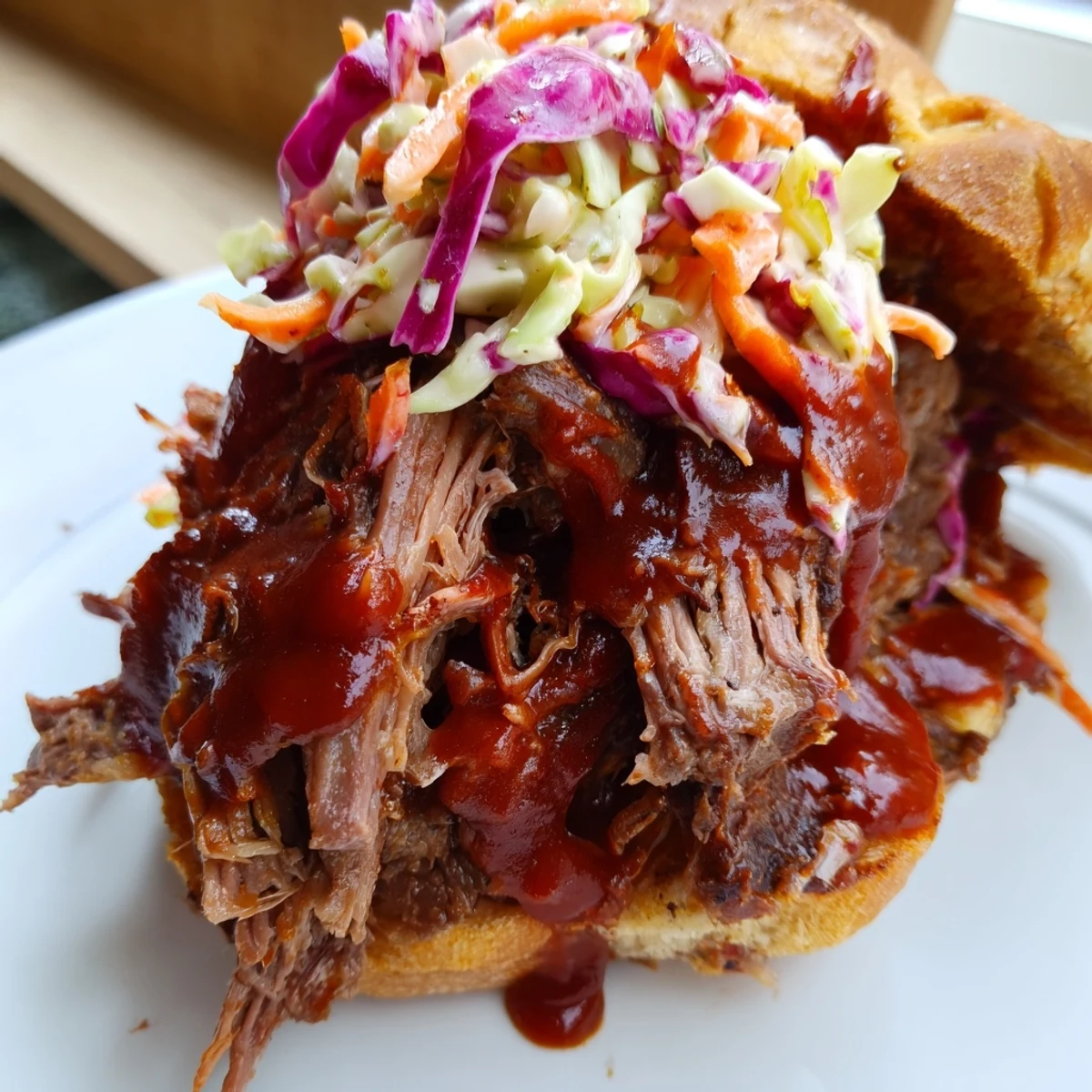 Golden toasted buns hold juicy Slow Cooker Pulled Beef Sandwiches topped with crunchy, creamy coleslaw.