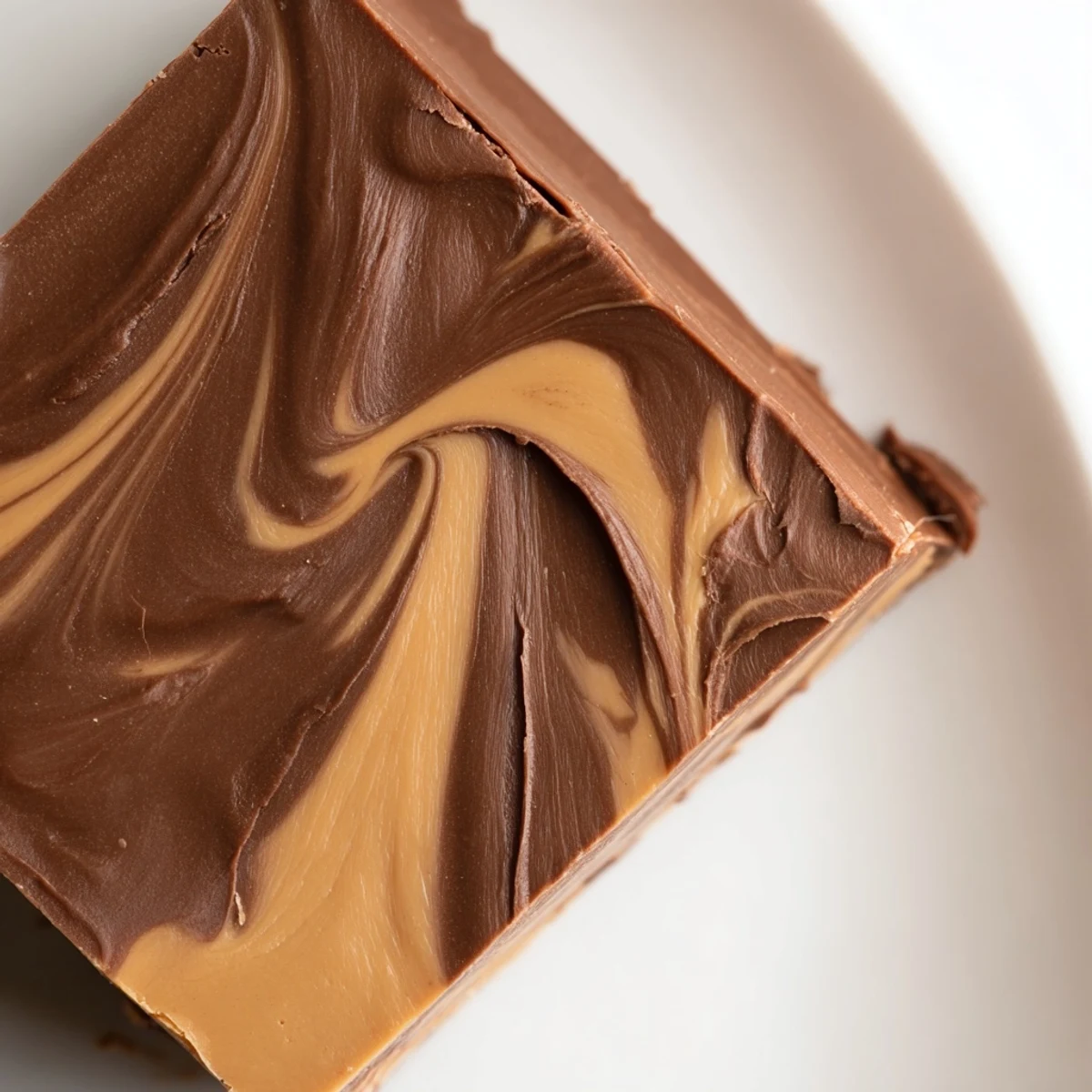 Chocolate Peanut Butter Fudge Squares with a rich, marbled chocolate and peanut butter surface, ready to slice and serve as a decadent treat.