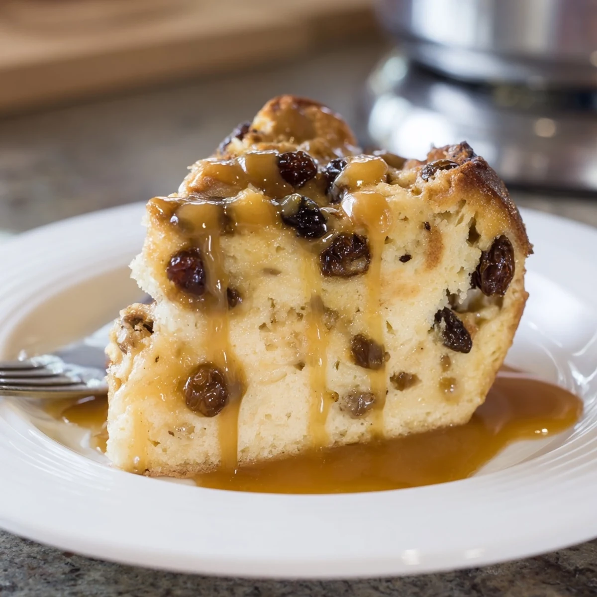 Golden brown New Orleans Bread Pudding with Caramel Sauce in a white dish, served with vanilla ice cream.