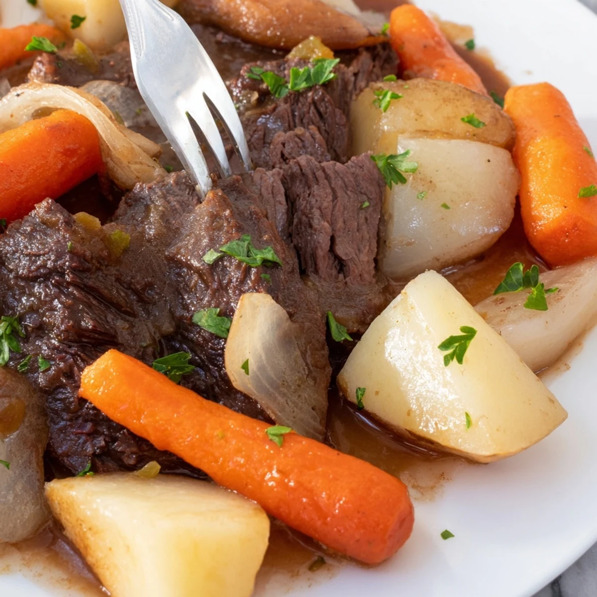 Freshly chopped parsley garnishes this hearty Irish Beef Pot Roast with Root Vegetables served in a Dutch oven.