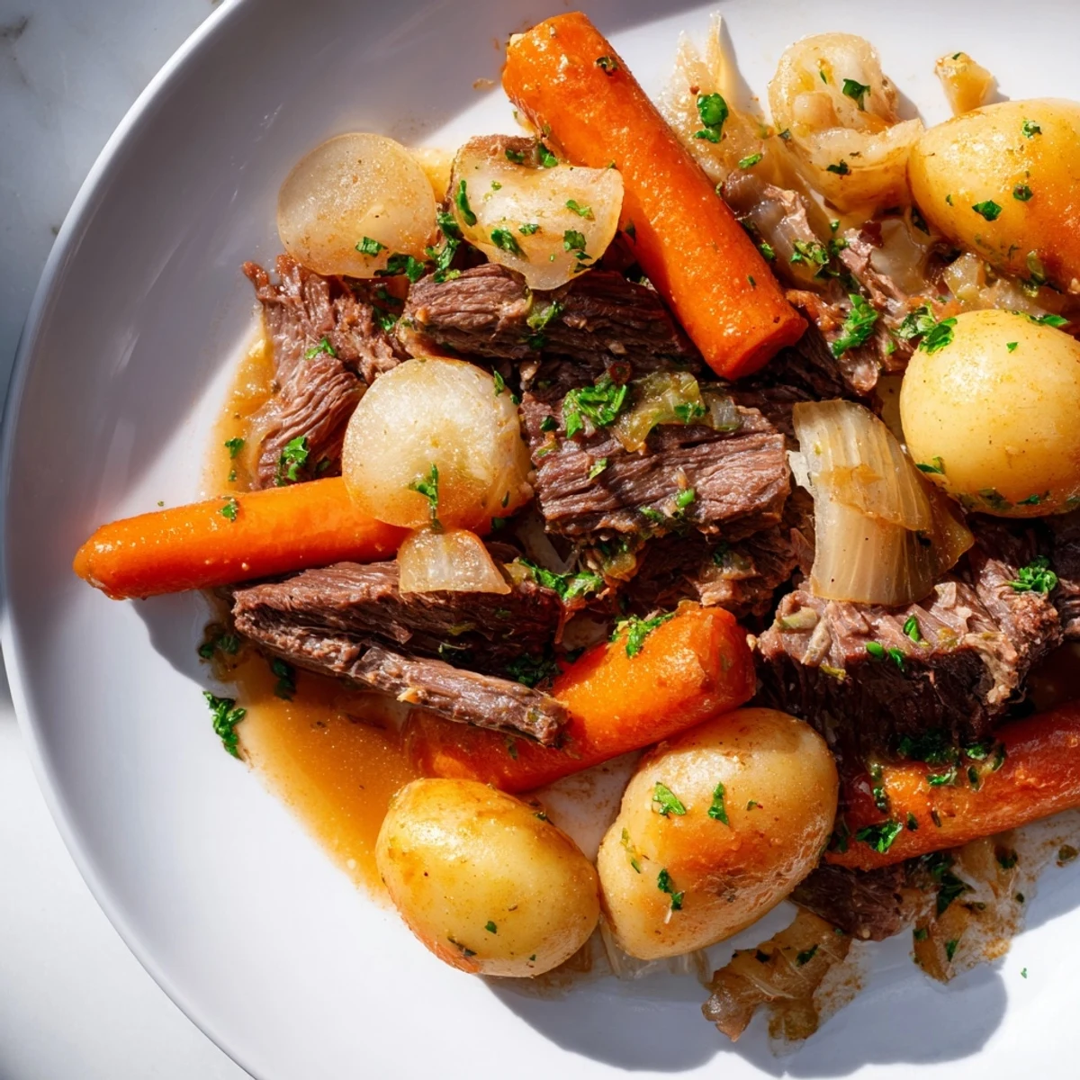 Steaming Irish Beef Pot Roast with Root Vegetables featuring tender beef, carrots, parsnips, and potatoes in a dark gravy.