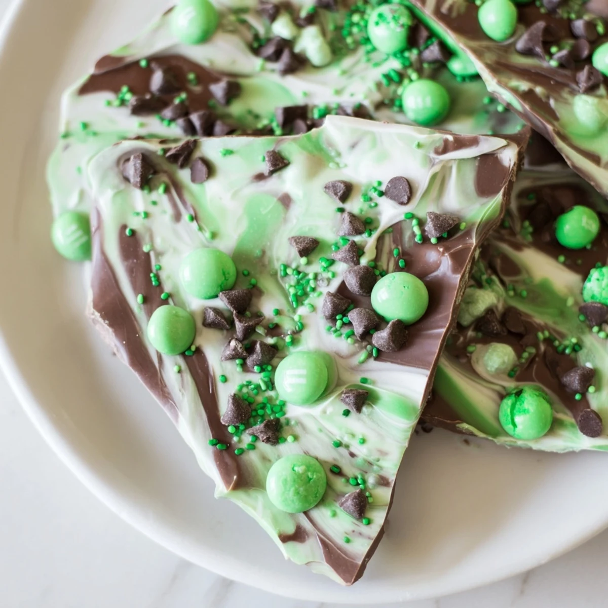 Ready-to-serve St. Patricks Day Mint Chocolate Bark arranged on a platter, perfect for a holiday dessert table.