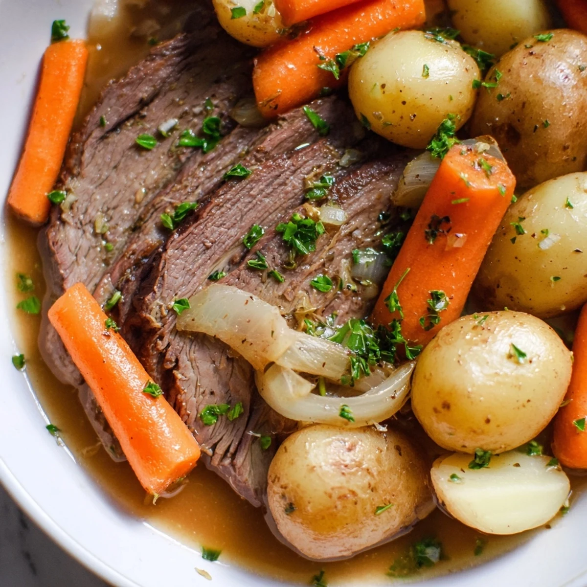 Close-up of a fork-tender Irish Beef Pot Roast with Carrots and Potatoes, showcasing juicy meat, soft vegetables, and aromatic thyme and bay leaves.