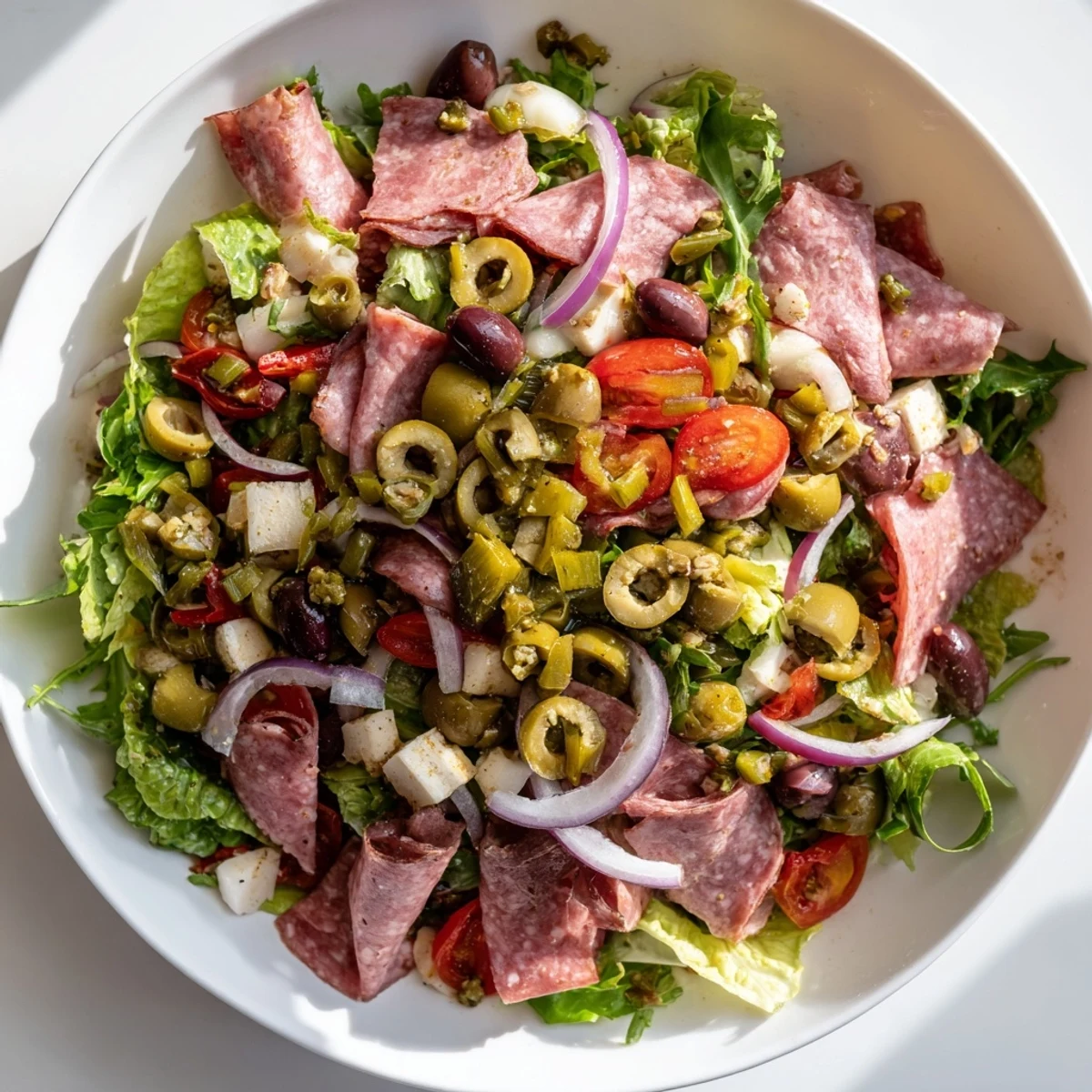 Ready to serve, this New Orleans Muffuletta Salad offers a fresh twist on the classic sandwich with cured meats, marinated vegetables, and creamy mozzarella and provolone cheese.