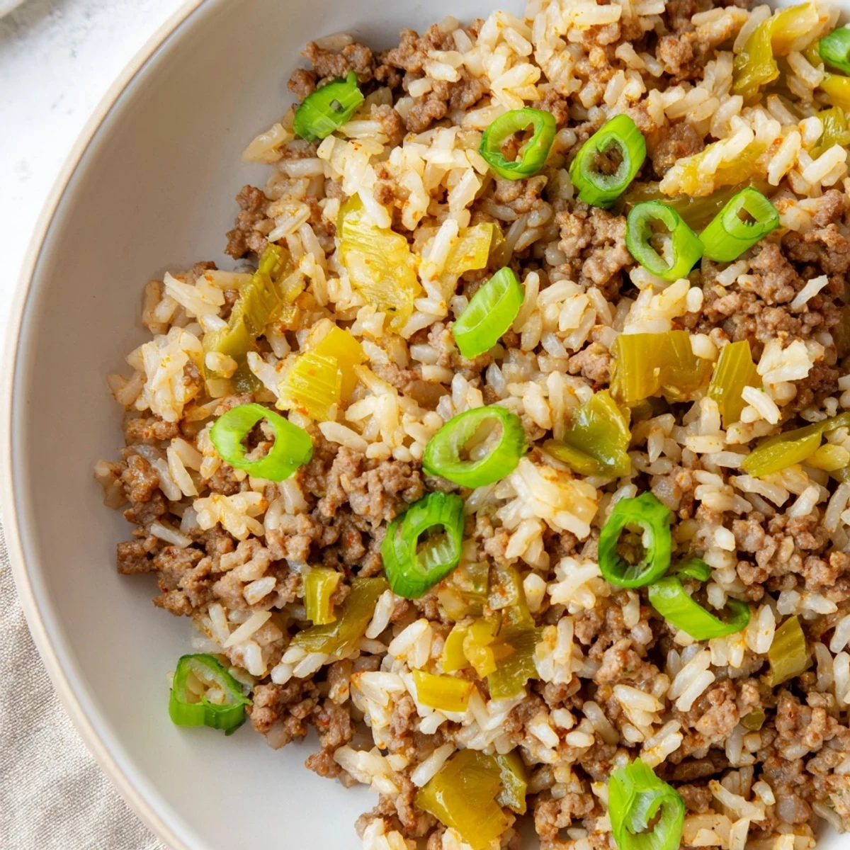 Cajun Dirty Rice with Ground Beef simmered in a skillet with fluffy rice and Cajun spices, ready to serve.