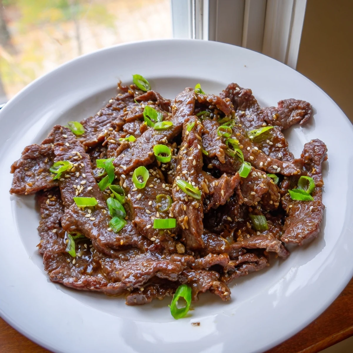 Aromatics like garlic and ginger shine in Ultimate Slow Cooker Mongolian Beef served over fluffy rice.
