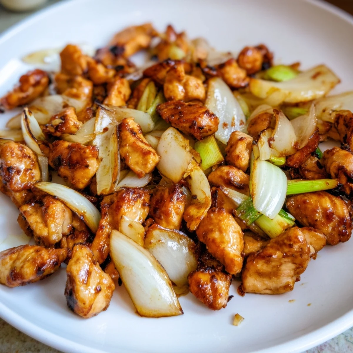 Vietnamese Lemongrass Chicken sizzling in a hot wok, releasing fragrant steam from fresh lemongrass, garlic, and chili.