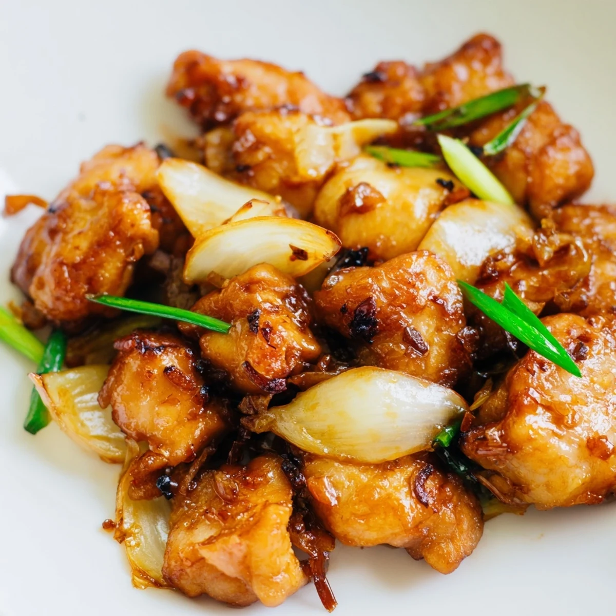 Golden-brown Vietnamese Lemongrass Chicken pieces glistening with aromatic marinade, served alongside fluffy steamed jasmine rice and crisp cucumber slices.