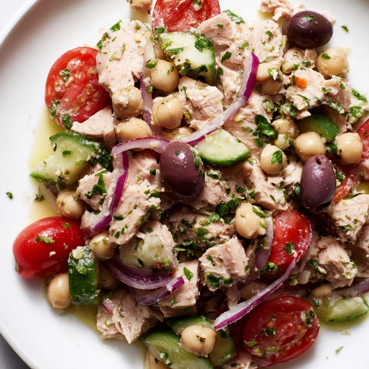 Mediterranean-style bowl featuring tender tuna, creamy chickpeas, crisp tomatoes, and cucumber tossed with herbs