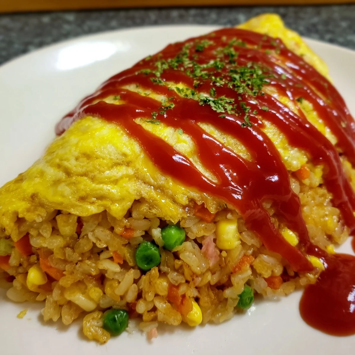 Golden omelet wrapped around savory ketchup fried rice in this Japanese Omurice