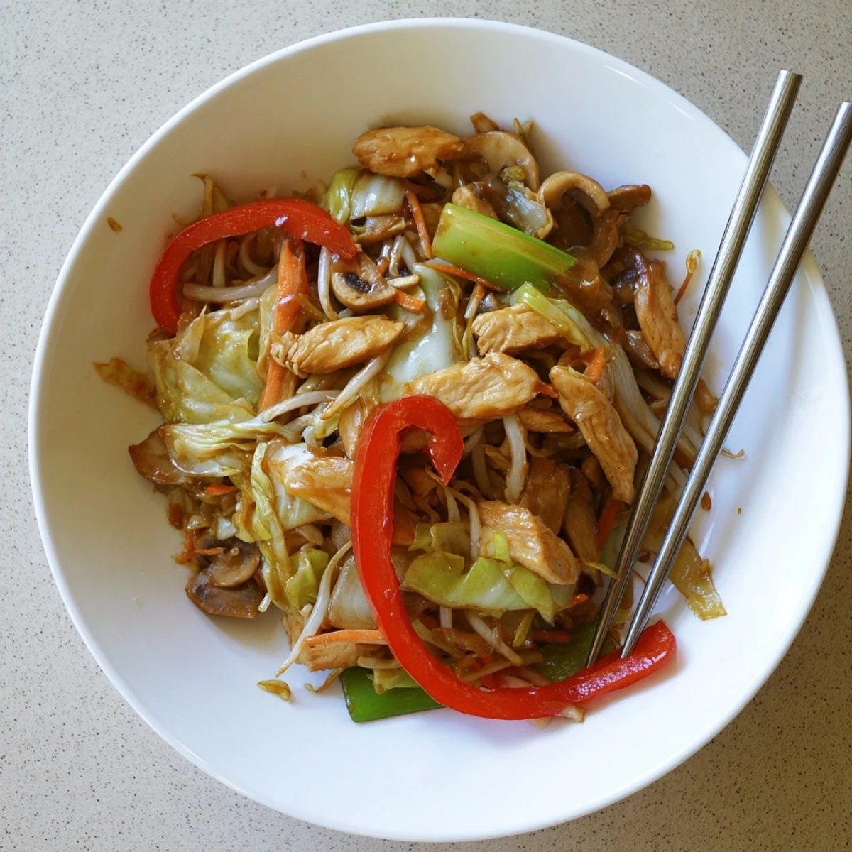 Sizzling wok of Chop Suey featuring crisp vegetables and meat over steaming white rice