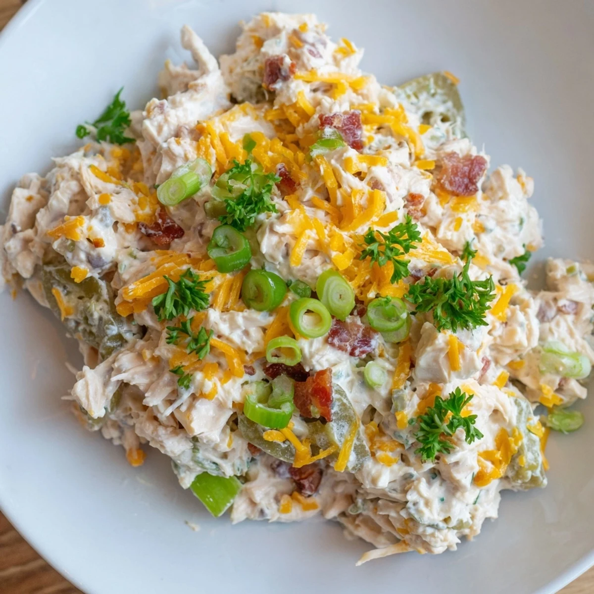 Creamy low carb jalapeno popper cottage cheese chicken salad served in lettuce cups with crispy bacon crumbles