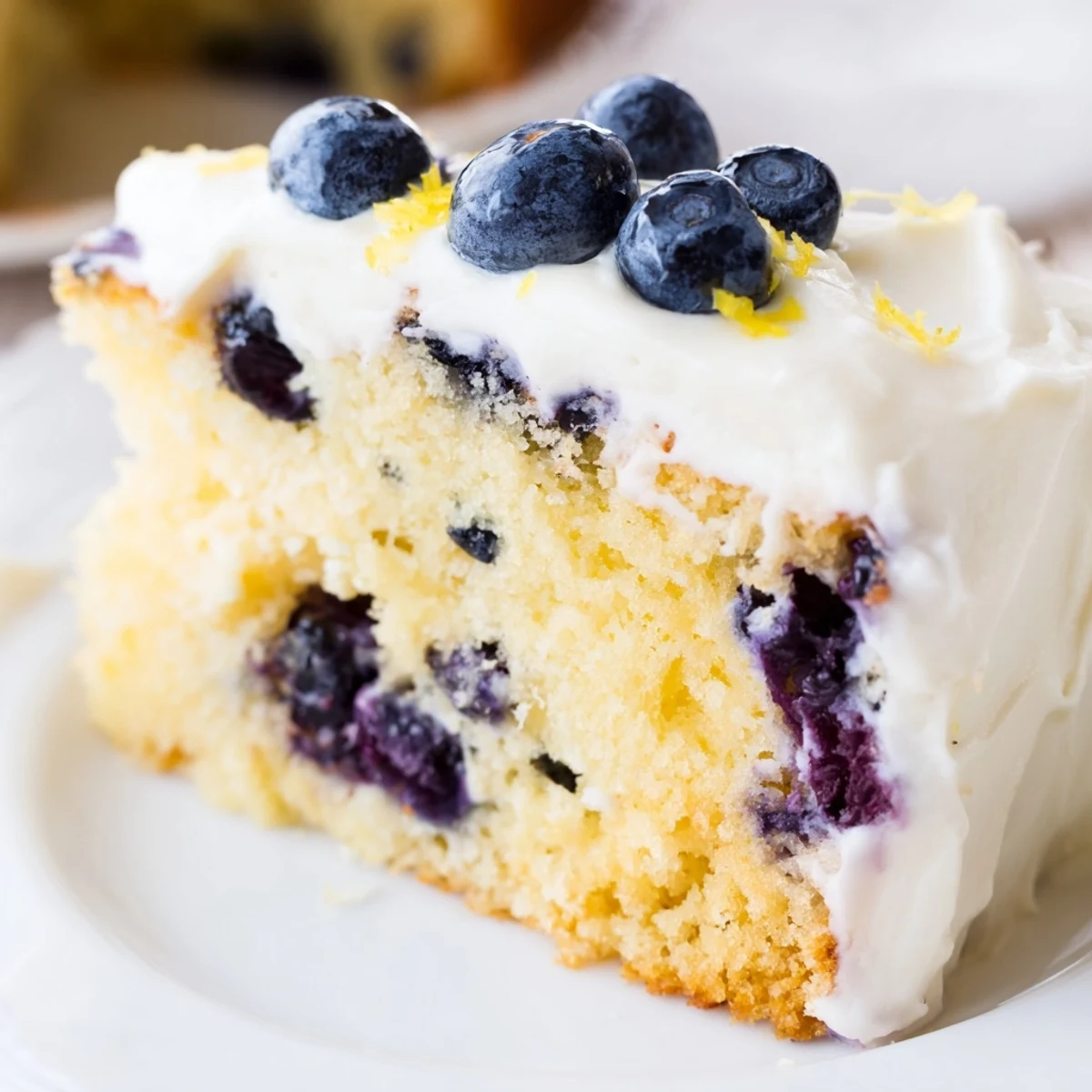 Homemade lemon blueberry cake with fluffy layers and fresh blueberries throughout