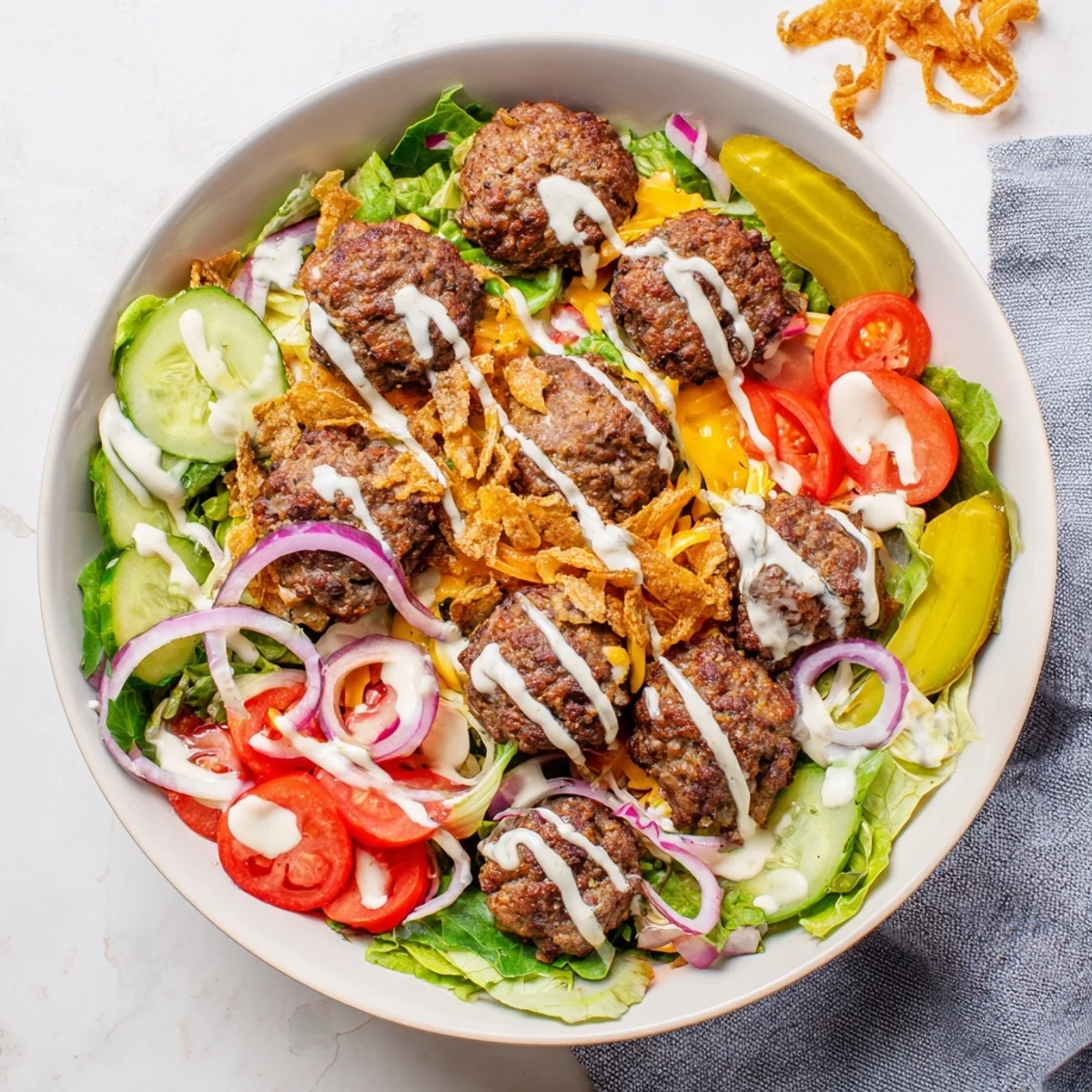 Crispy ground beef patties served over fresh greens in this smash burger bowl