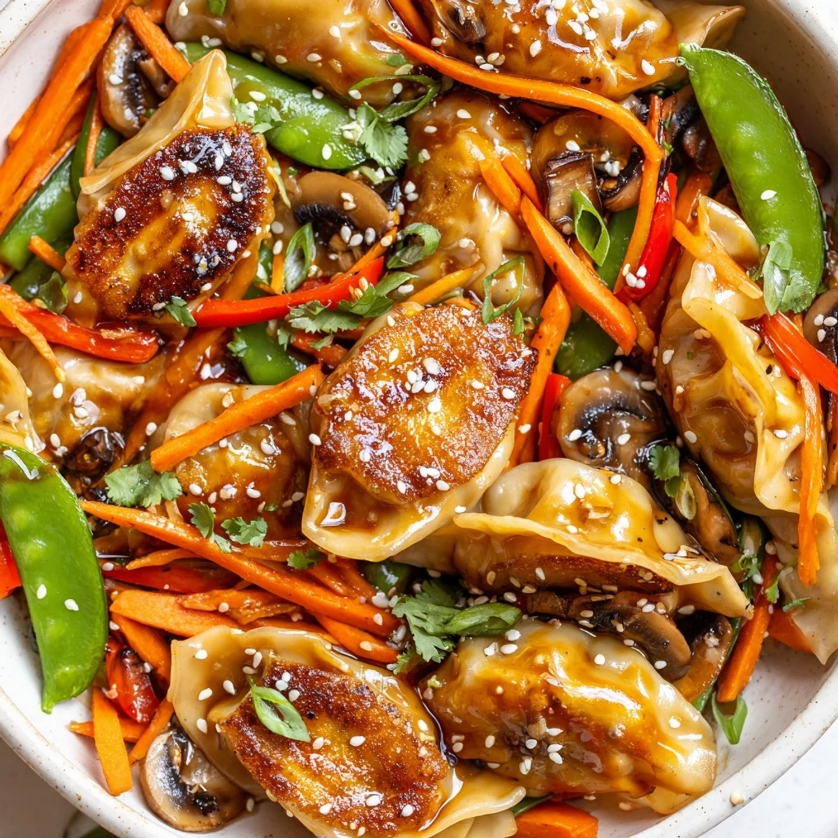 Golden potsticker stir fry with colorful bell peppers snap peas and savory sesame soy sauce