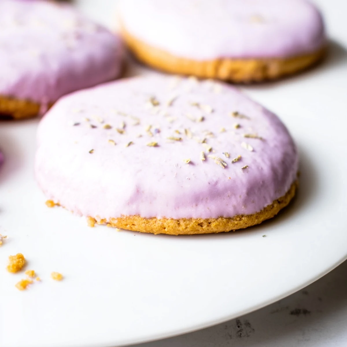 Buttery lilac sugar cookies cooling on a wire rack with lightly golden edges