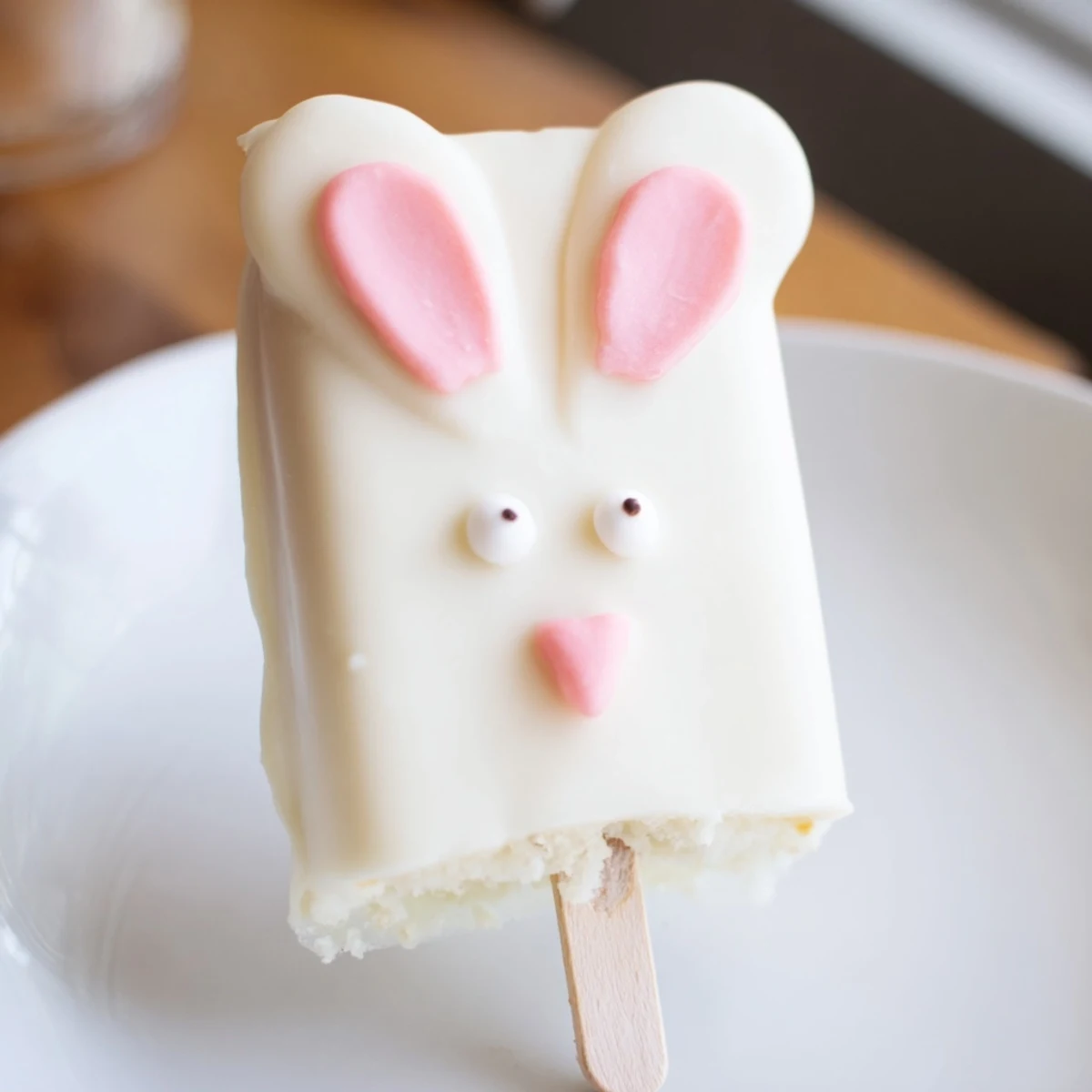 Festive bunny-shaped cakesicles coated in smooth white chocolate for spring celebrations