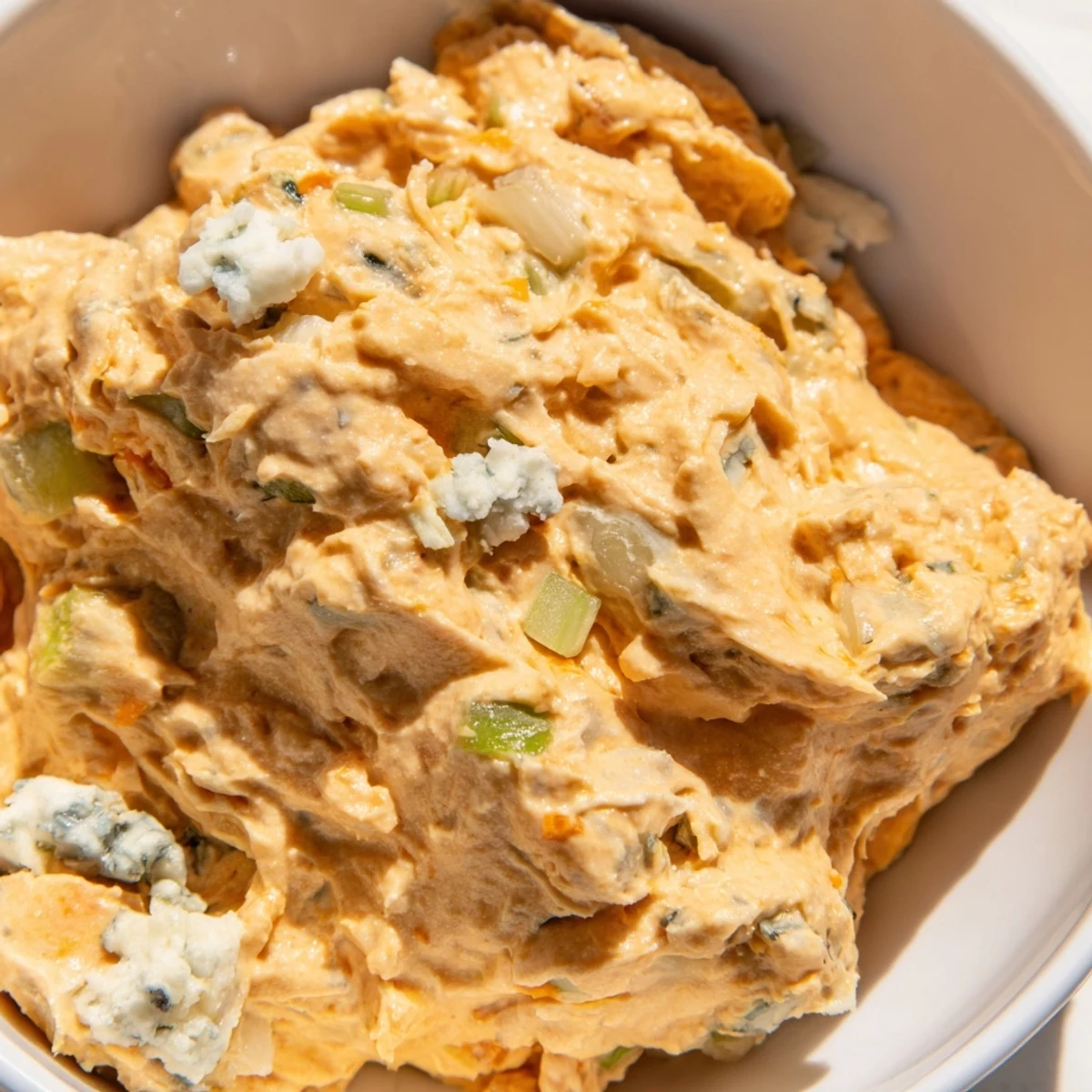 Tangy Buffalo Pickle Dip topped with chopped chives and pickle slices, ready for game day appetizer spread