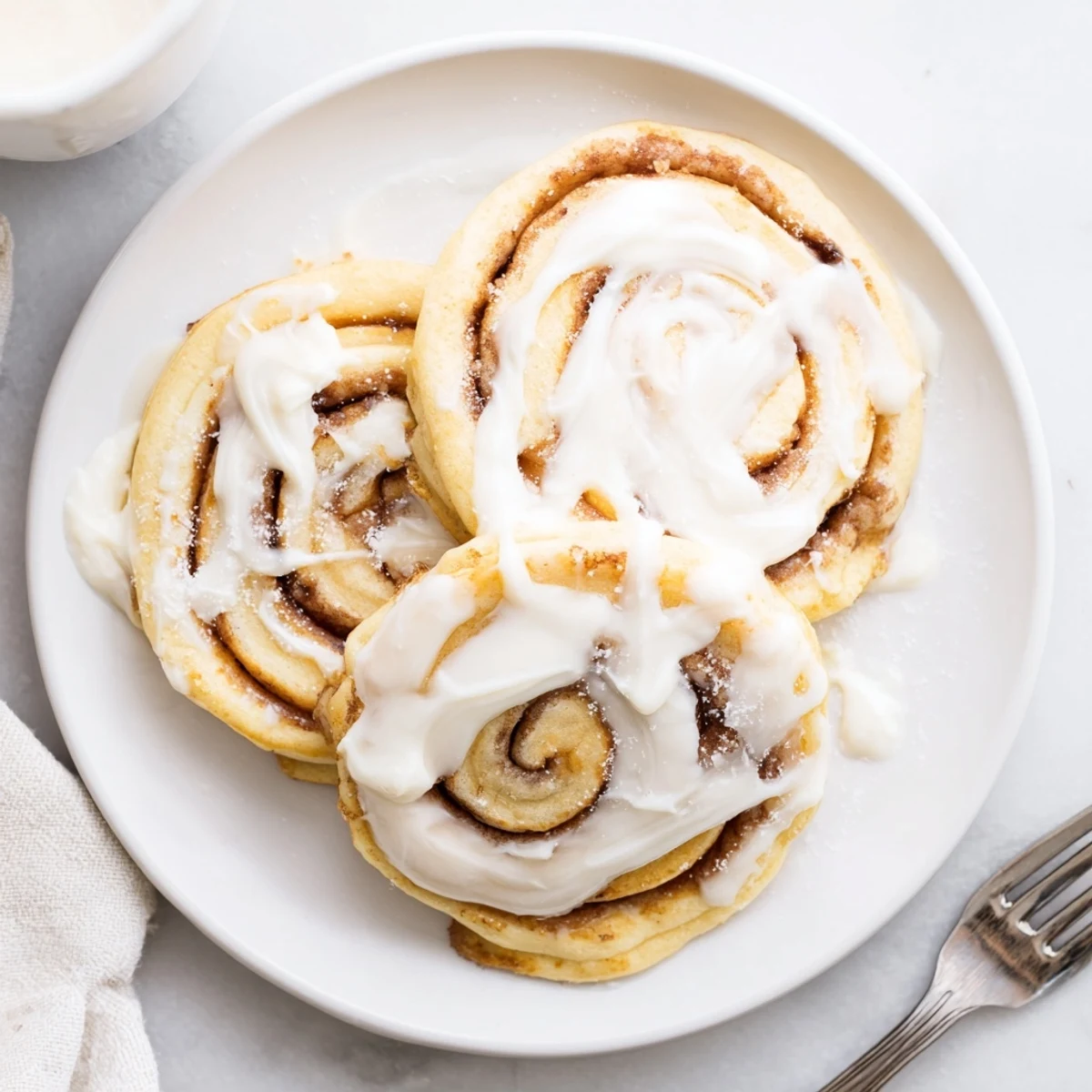 Fluffy pancakes swirled with warm cinnamon sugar filling on a white plate