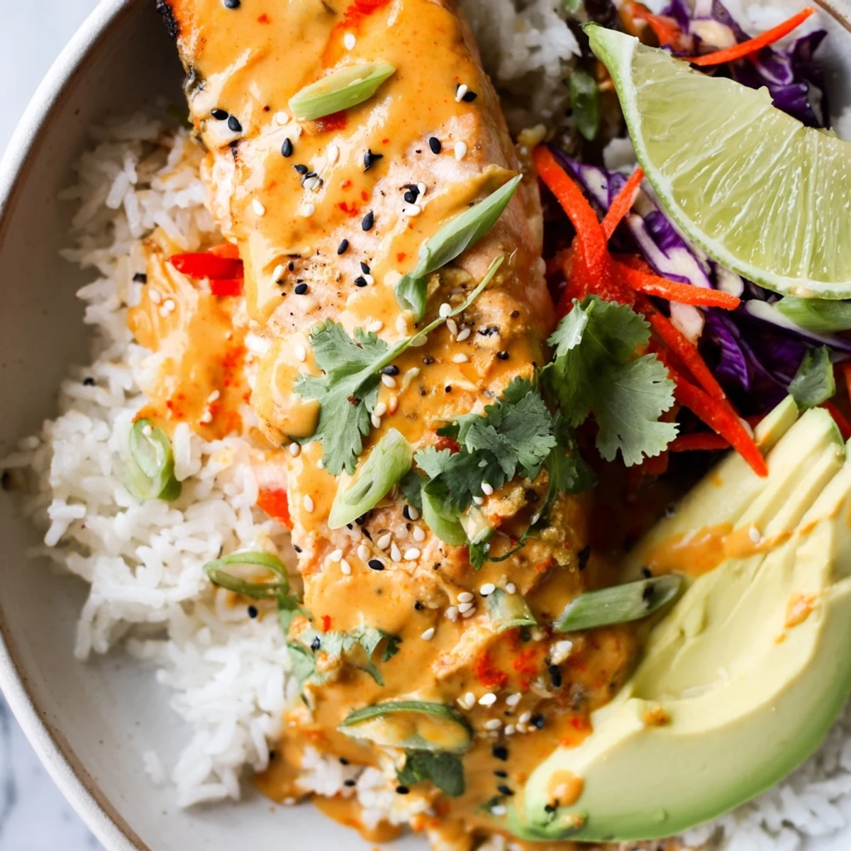 Spicy sweet Bang Bang Salmon Bowls recipe drizzled with sriracha mayo and sesame
