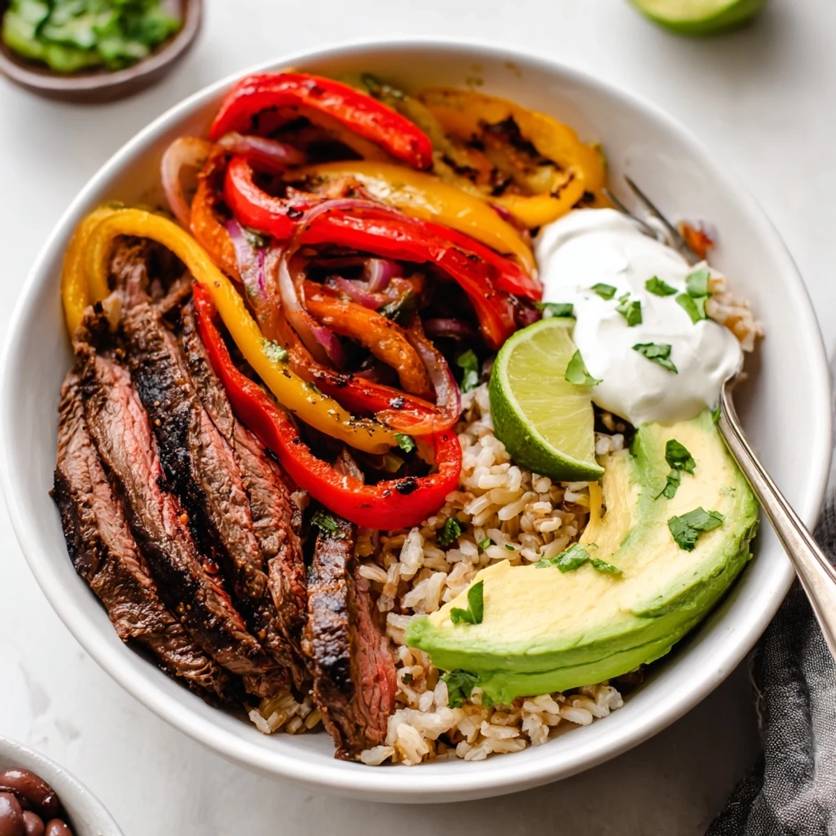 Steak Fajita Power Bowls with sizzling marinated steak, colorful peppers, lime