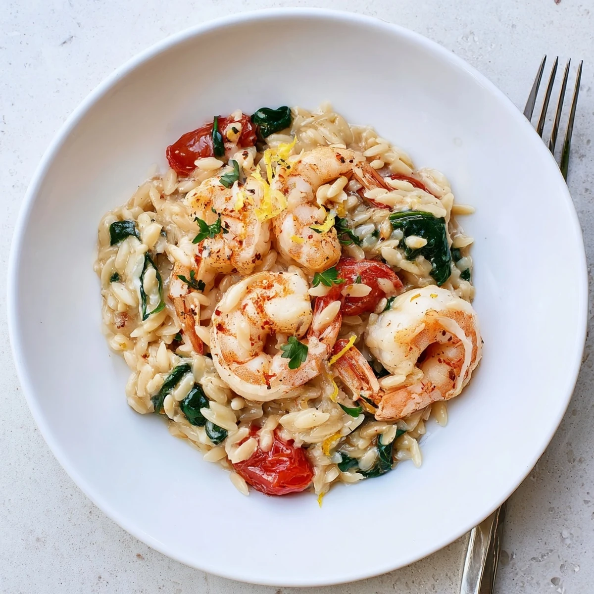 Creamy Shrimp Orzo Recipe showing plump shrimp, toasted garlic, bubbling cream