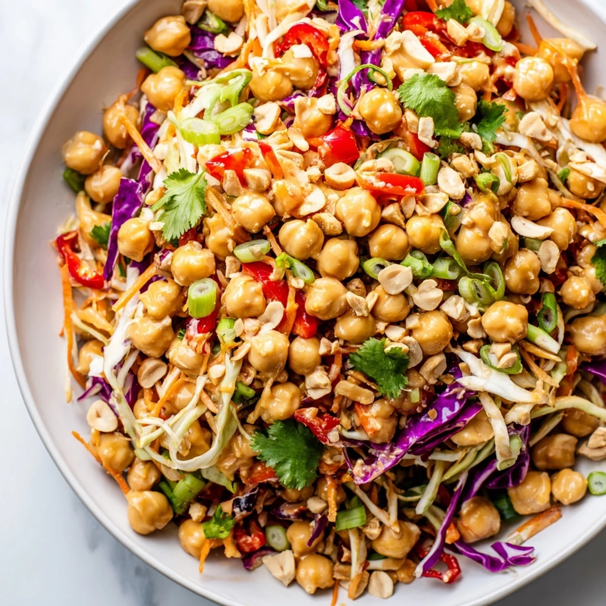 Golden chickpeas tossed with crisp vegetables in zesty Thai peanut dressing