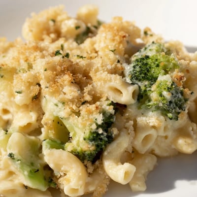 A close-up of Baked Macaroni and Cheese with Broccoli, revealing bubbling cheese sauce, perfectly cooked elbows, and crisp breadcrumb topping, ready to serve for dinner.